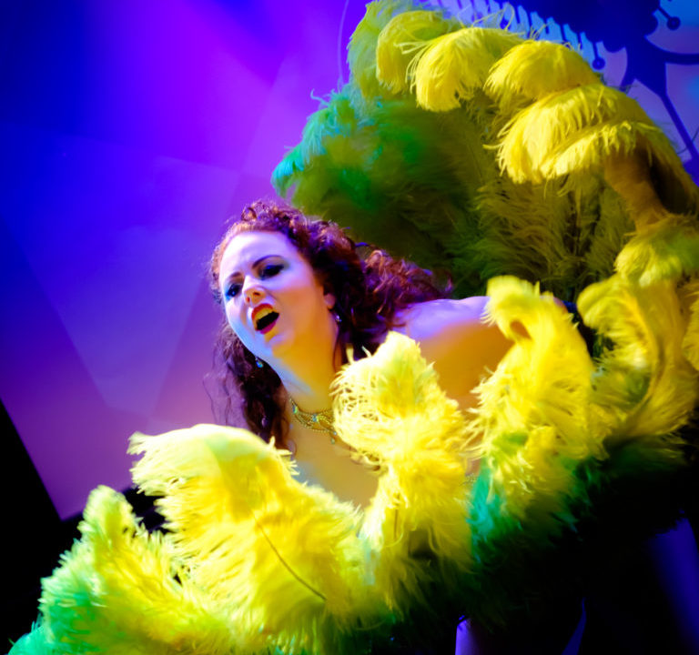 Isabelle Epoque performer and producer of shows Iconic Cabaret and Pies n Pasties is fan dancing with Chartreuse colored ostrich feather fans